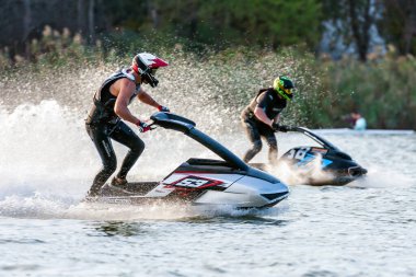 Krasnodar, Rusya - 24 Ekim 2020: Jet ski süper jet yarışçıları, Güney Rusya Aquabike Şampiyonası 'nda yarışırken günbatımında su sıçratan su araçları kullanıyorlar