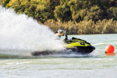 Krasnodar, Rusya - 24 Ekim 2020: Jet kayak yarışçısı Güney Rusya Aquabike Şampiyonası 'nda yarışırken su aracını dönüş ve sıçrama yaparak sürüyor.