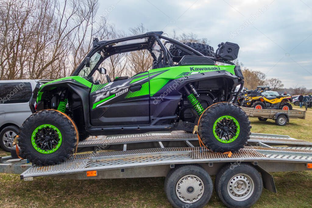 Afipsip, Russia - October 31, 2020: Green Kawasaki Teryx buggy on trailer ready for Mud Racing contest. ATV SSV motobike competitions are popular extreme sport and outdoor activity