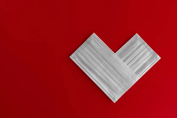 Two Close White Medical Masks Stacked Shape Heart Red Background — Stock Photo, Image