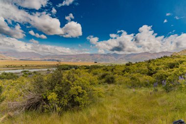 Uzak kırsal bölgeler, dağların altındaki yemyeşil bitkileri gösteriyor.
