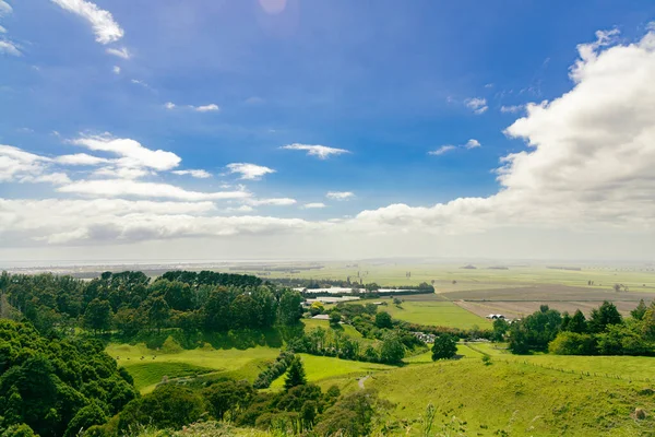 Kırsal alanlar dağınık bulutların altında uzanır vadi otlakları