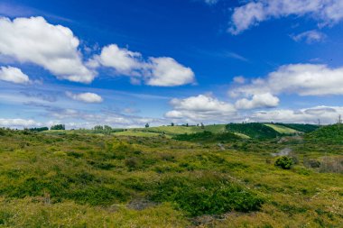 Sunny countryside shows open fields clouds landscape meadow pasture grassland