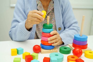 Asyalı yaşlı bir kadın, geliştirme oyunu oynuyor..