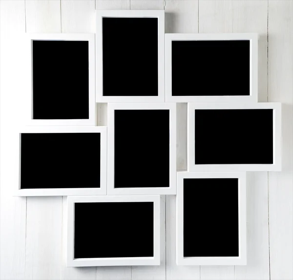 Nueve espacios en blanco en el marco de fotos fijado en la pared — Foto de Stock