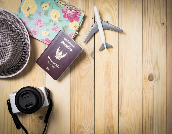 Air Traveller equipments flat lay on wooden background.