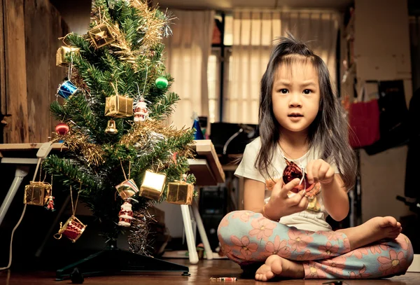 Little Asian Girl is Decoration Christmas Tree