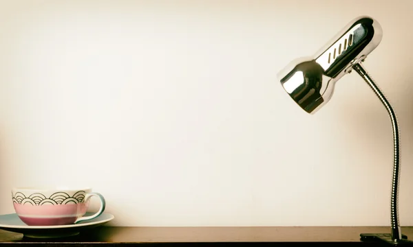 Candeeiro de mesa de metal com xícara de chá e espaço de cópia no meio — Fotografia de Stock