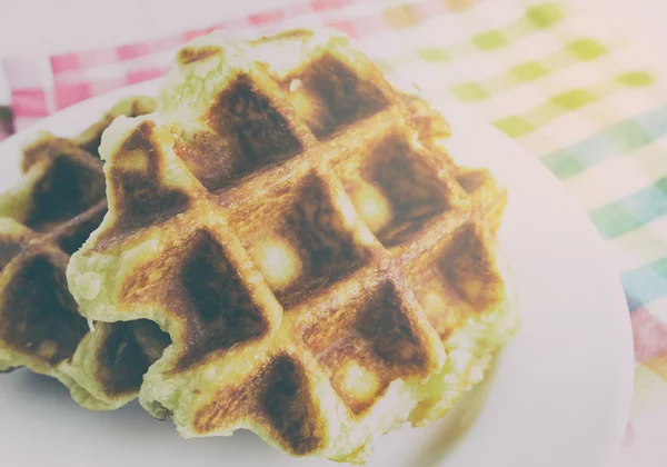 Baked golden honey waffles on white plate in vintage tone. — Stock Photo, Image