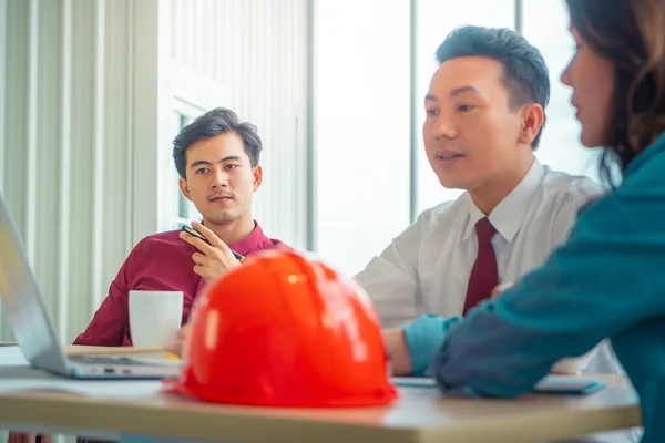 Construction Boss with business man engineer and architect is discussing project details on laptop computer.