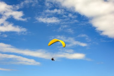 Paragliding flying with blue sky clipart