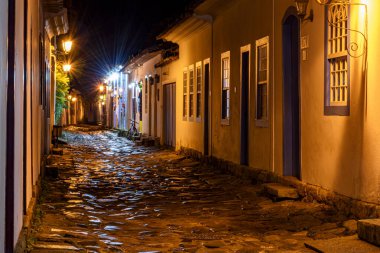 Night view of the city of Paraty with its old colonial style houses and the brightness and colors of the city lights reflected in the cobbled streets clipart