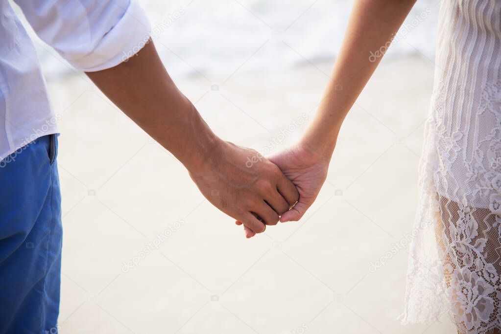 Young couples shaking hands to the sea.happy and be smile holding hands. Travel beach summer vacation. Travel relax