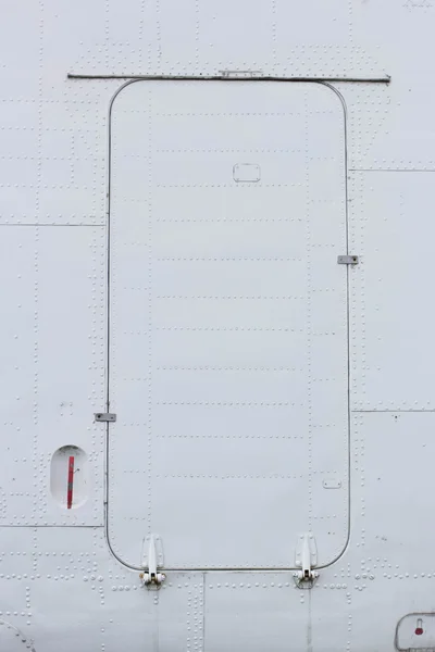 Part of the aircraft, aluminum sheet with rivets and hatch — Stock Photo, Image