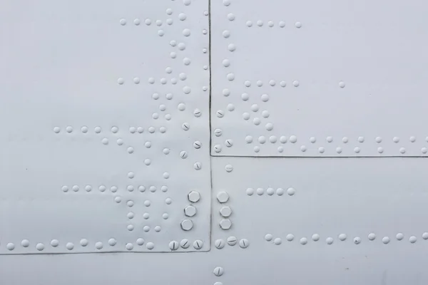 Part of the aircraft, aluminum sheet with rivets and hatch — Stock Photo, Image