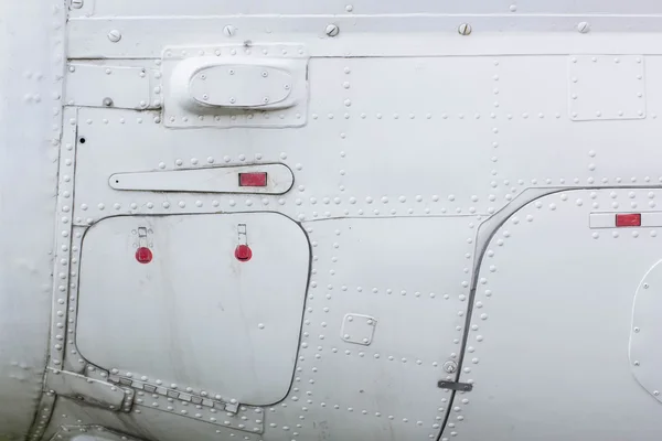 Part of the aircraft, aluminum sheet with rivets and hatch — Stock Photo, Image