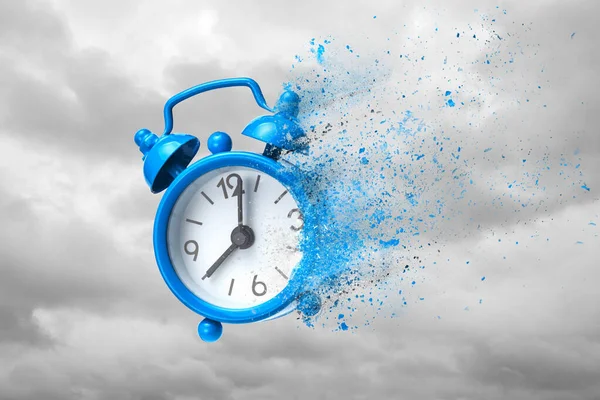 Time is running out. Blue alarm clock waving like sand or ashes against background of clouds — Stock Photo, Image