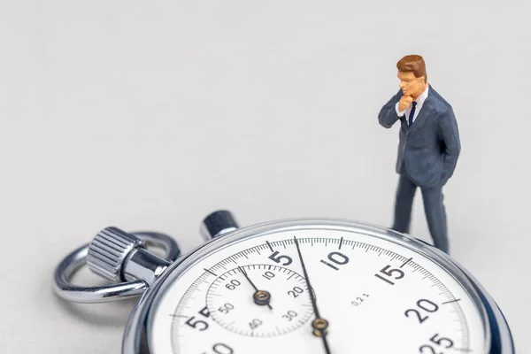 Businessman in a suit looks at the stopwatch. Fast business solution concept. Template Copy space for text — Stock Photo, Image