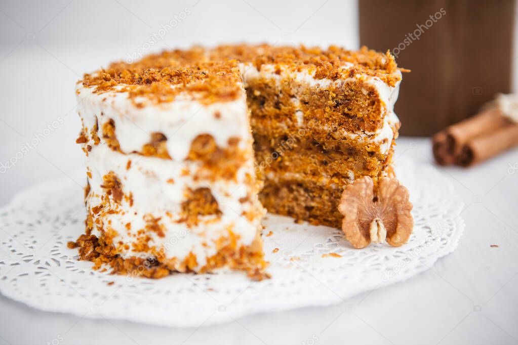 Homemade cake with honey and walnuts on a light background