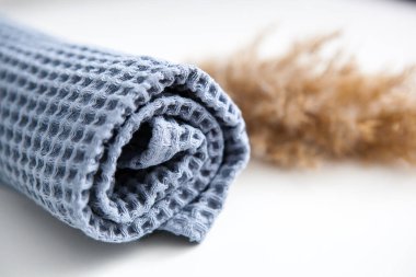 yumuşak voluminous lüks mavi havlu beyaz arka planda kuru pampa otları ile