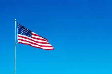 ABD bayrağı sinekli bir rüzgar mavi gökyüzü arka plan üzerinde yerleştirmek için metin