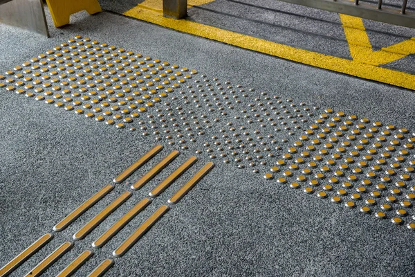 Metal tactile paving for blind people in big city — Stock Photo, Image