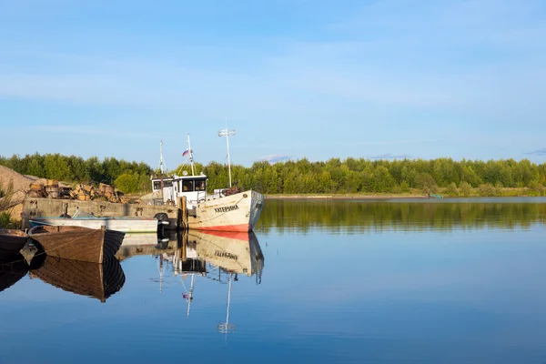 Starej łodzi znajduje odzwierciedlenie w czystej wodzie jeziora — Zdjęcie stockowe