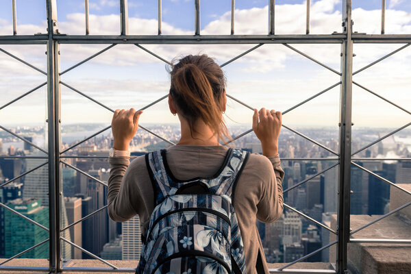 Young woman looking from top at New York skyline