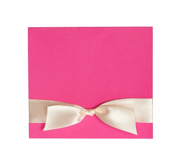 Pink card with beige bow on white background — Stock Photo, Image