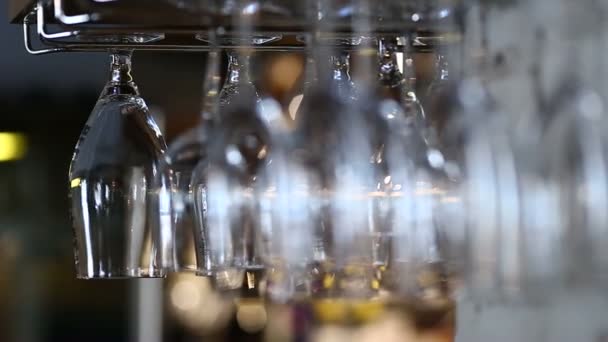 Glasses hanging upside down in cafe restaurant wine — Stock Video