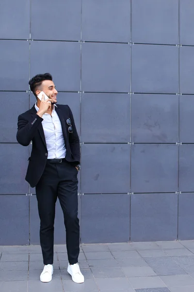 Bel homme arabe parle sur le téléphone intelligent dans le centre d'affaires — Photo
