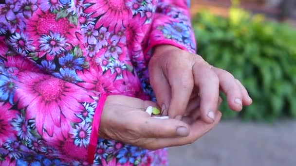 Elderly older female holds tablets drinks water — Stock Video