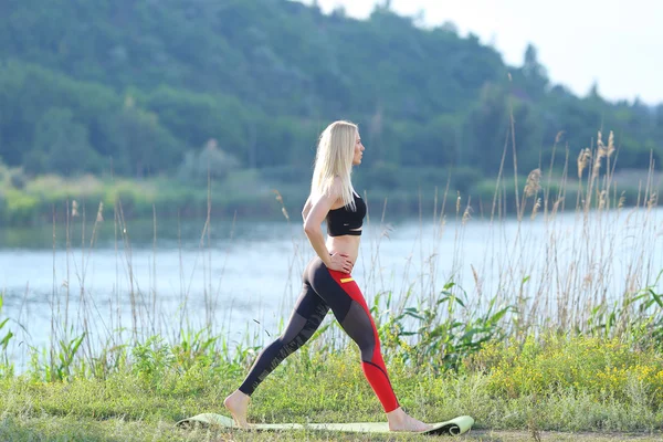 Young beautiful woman shows press stomach workout training wearing top. — Stock Photo, Image