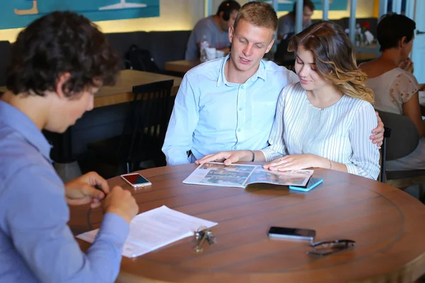 Young couple buy apartment with realtor contract