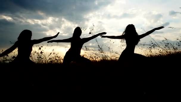 Silhouette tre ragazze Yoga sullo sfondo del cielo del tramonto — Video Stock