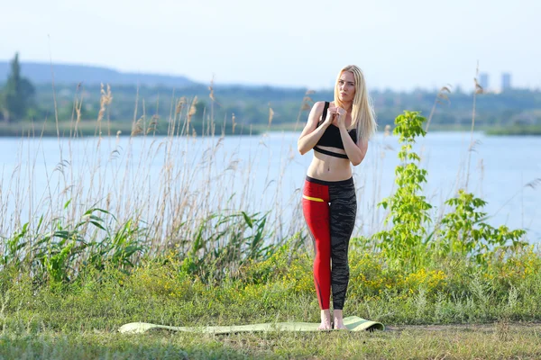 Young beautiful woman squats shows result press on stomach workout training wearing top