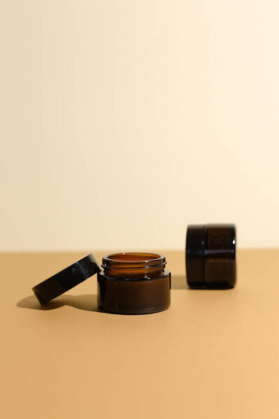 A few beauty hygiene Amber glass jars on neutral background