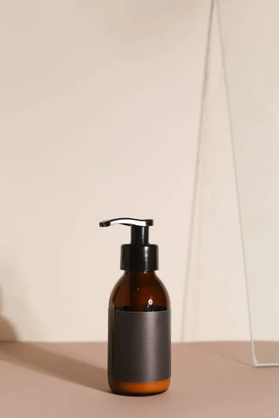 Beauty natural skincare products development concept. Dermatologist cosmetic skincare bottle with pump dispenser and organic ingredient on neutral background.