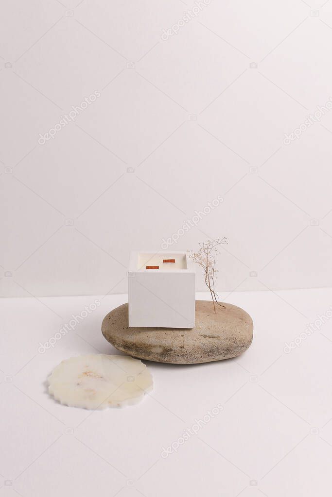 scented candles on off white background in rock holder