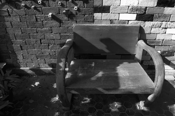Деревянная скамейка на кирпичном фоне . — стоковое фото