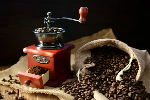 Coffee mill and coffee beans on dark background