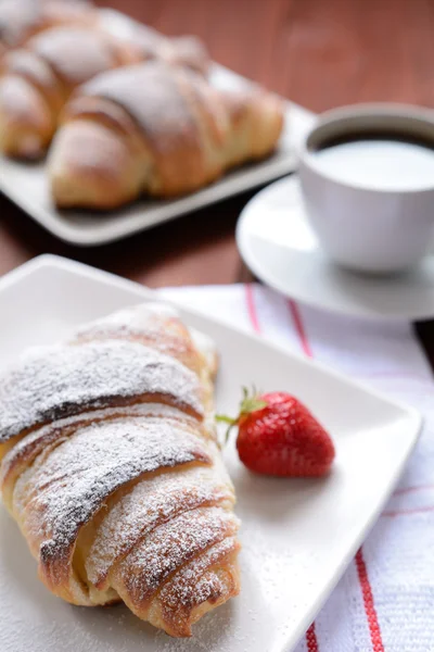 Croissant on a wooden background — Stock Photo, Image