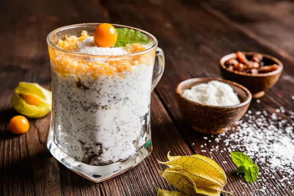 Yogurt with chia, coconut, honey and physalis puree — Stock Photo, Image