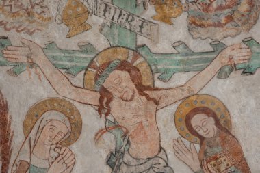 Christ is nailed on a green cross. Mary and St. John are mourning, an old mural-painting in Skibby church, Denmark, June 28, 2021 clipart