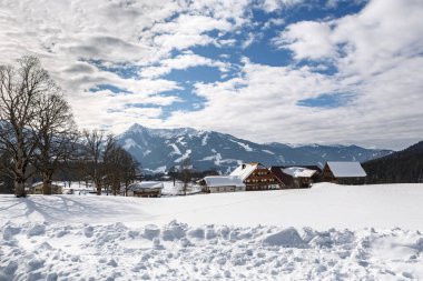 Winter landscape with snow-covered mountains near Schladming, Austria under clear blue sky