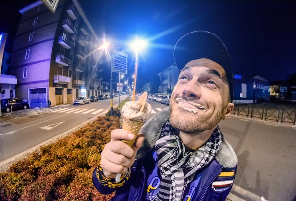 Man with ice cream at night in the city — Stock Photo, Image