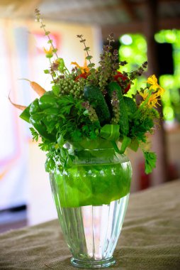 Yemek masasında bir buket yabani çiçek ve sebze..