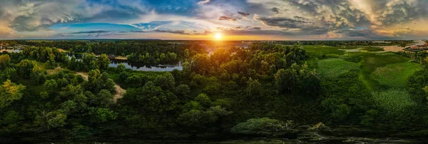 Landscape from above. Trees and river at sunset. Drone photo.