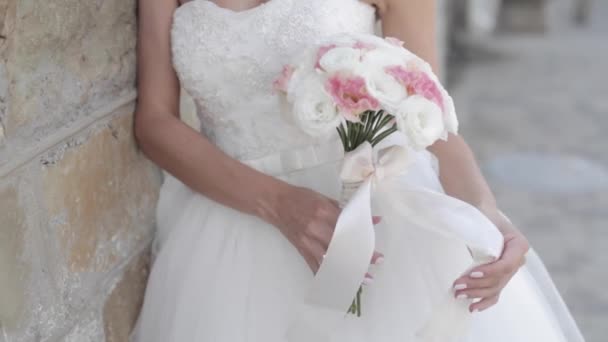 Beautiful bride standing at the wall — Stock Video