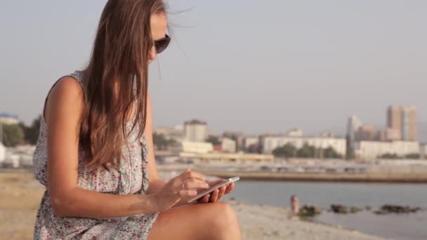 Jonge vrouw aan kust met mobiele telefoon — Stockvideo